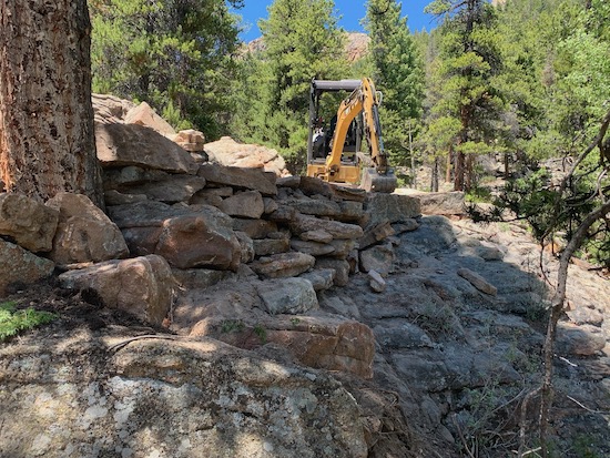 Rock retainer wall on cliff edge